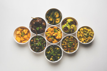 Indian sabzi / vegetable fried recipes served in white bowl over moody or colourful background. selective focus