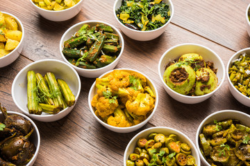 Indian sabzi / vegetable fried recipes served in white bowl over moody or colourful background. selective focus