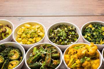 Indian sabzi / vegetable fried recipes served in white bowl over moody or colourful background. selective focus