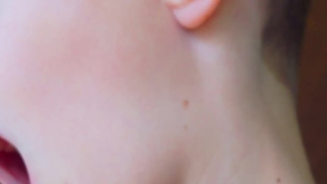 child's mouth sings into the microphone.close-up