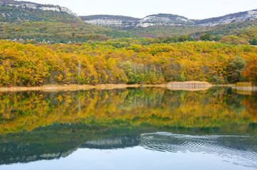 Fototapeta na wymiar Autumnal landscape with lake and hills