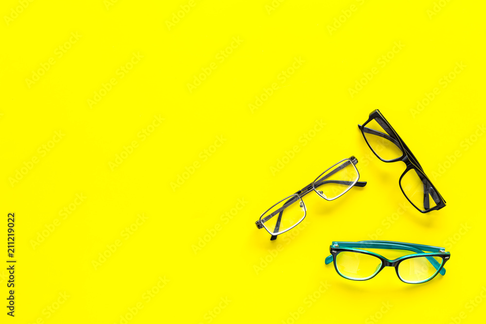 Wall mural glasses concept. set of glasses with different eyeglass frame and transparent lenses on yellow backg