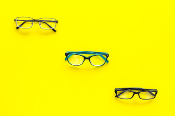 Glasses concept. Set of glasses with different eyeglass frame and transparent lenses on yellow...