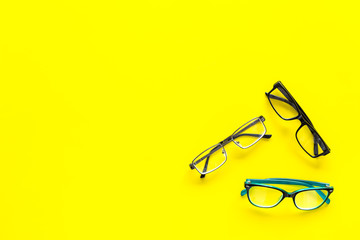 Glasses concept. Set of glasses with different eyeglass frame and transparent lenses on yellow...