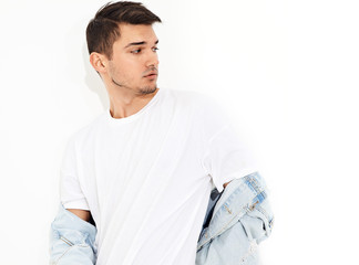 Portrait of handsome young model man dressed in jeans clothes posing on white background. Isolated