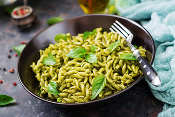 Fusilli pasta with  pesto sauce, green peas and basil. Italian food.