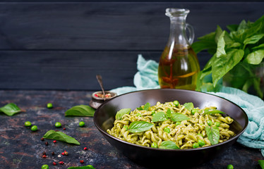 Fusilli pasta with  pesto sauce, green peas and basil. Italian food.