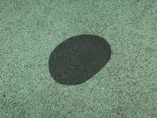 black oval on rubber playground