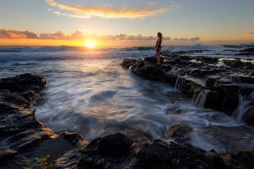 Girl watching the sunset at Cap La Houssaye in Saint-Paul, Reunion Island