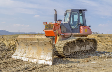 bulldozer on loamy ground