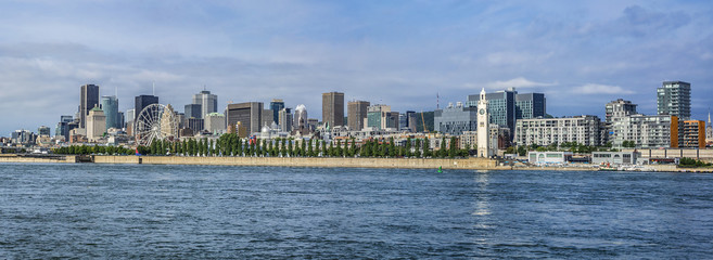 Gorgeous skyline of Montreal as seen across the St. Lawrence River on a sunny day. Montreal, Quebec, Canada.