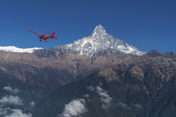 Fototapeta na wymiar Ultralight plane flies over Pokhara and Machapuchare