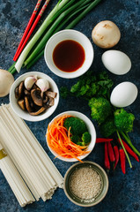 Asian food concept. Ingredients for asian cuisine. Vegetables, meat, noodles, eggs and sauce on a...