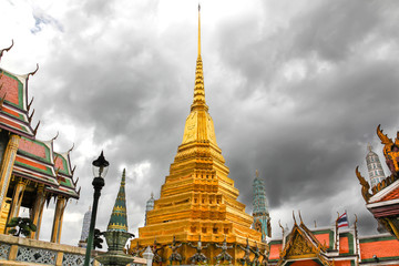 Wat Phra Kaew, Temple of the Emerald Buddha with cloudy sky in Bangkok, Thailand.