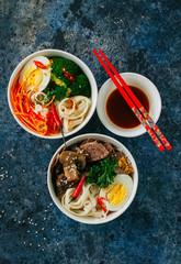 Asian food concept. Two different bowls with udon noodles.