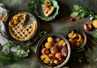 Fruit pie on colorful wooden rustic background with fresh peaches