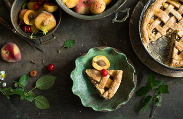 Fruit pie on colorful wooden rustic background with fresh peaches