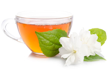 Glass cup of Tea with jasmine flowers and leaves isolated on white background