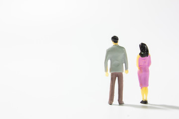 Miniature married couple back view on white background closeup.