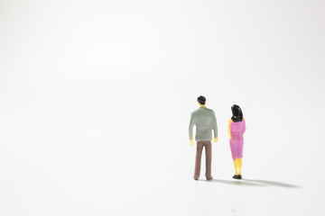 Miniature married couple back view on white background.