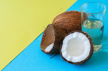 Coconut water, whole coconuts on a duo tone background. Coconut products concept.