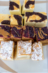 Different types of tasty cakes lying on a porcelain white plate