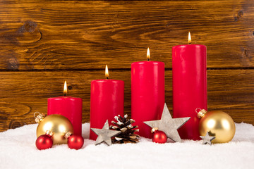 red advent candles with balls and stars