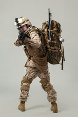 Soldier in camouflage holding rifle