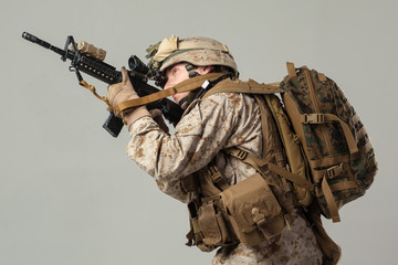 Soldier in camouflage holding rifle
