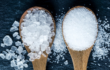 Different types of salt. Top view on two wooden spoons