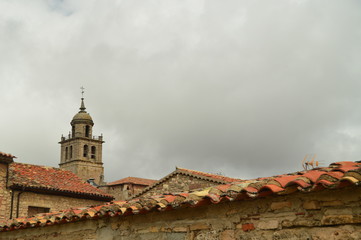 Fototapeta na wymiar Beautiful View Of The Roofs In Medinaceli As Main Theme In Its Top Is The Belfry Of The Church. March 19, 2016. Architecture Travel History. Medinaceli Soria Castilla Leon. Spain.
