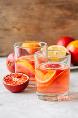 Citrus infused water with slices of fruits. Seasonal beverages concept.