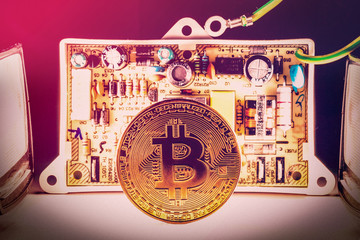 Bitcoin concept gold coin computer circuit board with bitcoin processor and microchips