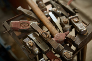 Working metal tools in blacksmith's workshop, close-up, selective focus, nobody