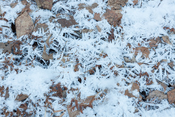 Snow crystals on ground close-up background