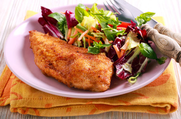 Fried chicken fillet and salad