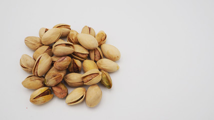 Pistachios on white background.It's roasted dried green nut or shell  close up  top view healthy snack  .