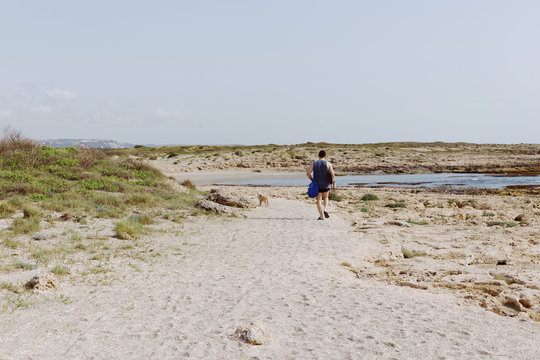 Man walking with dog at the sea