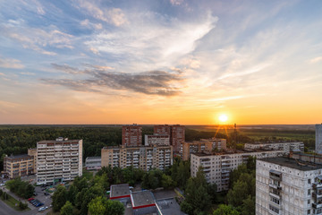 RUSSIA, MOSCOW, TROITSK - JUNE 28, 2018: View from the high on  Mikroraion V street district and clouds on sky aver the forest horizon at sunset time in summer