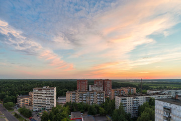 RUSSIA, MOSCOW, TROITSK - JUNE 28, 2018: View from the high on  Mikroraion V street district and clouds on sky aver the forest horizon at sunset time in summer