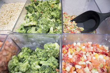Assortment of frozen vegetables in supermarket fridge