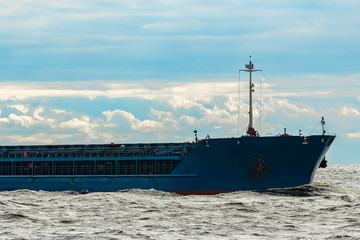 Blue cargo ship underway