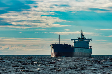 Obraz premium Blue cargo ship underway