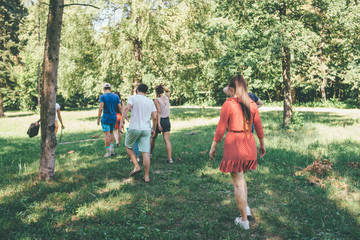 people are walking away together in the forest