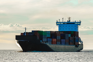 Black container ship underway