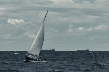 Blue sailboat at storm