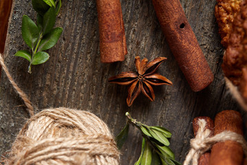 Christmas composition with chocolate biscuits, cinnamon and dried oranges on wooden background, close-up.