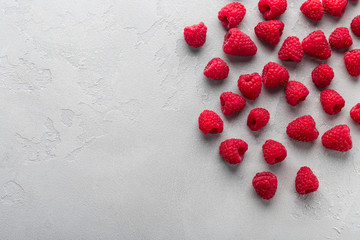 Fresh raspberry on light grey background, overhead view, copy space