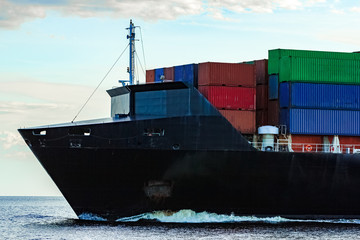 Black container ship underway