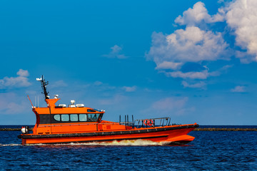 Orange pilot boat in action